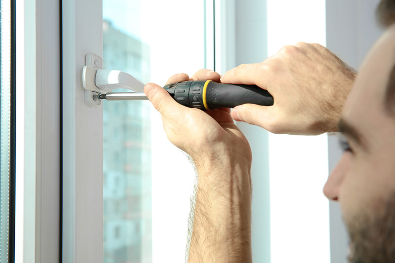 construction worker installing a window before scheduling home inspection services 